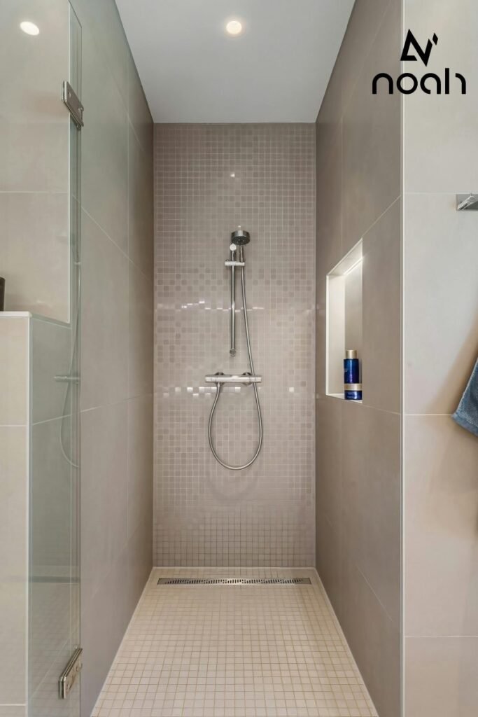 A classic small bathroom featuring linear floor drains